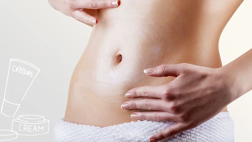 a woman applying creme to her stomach