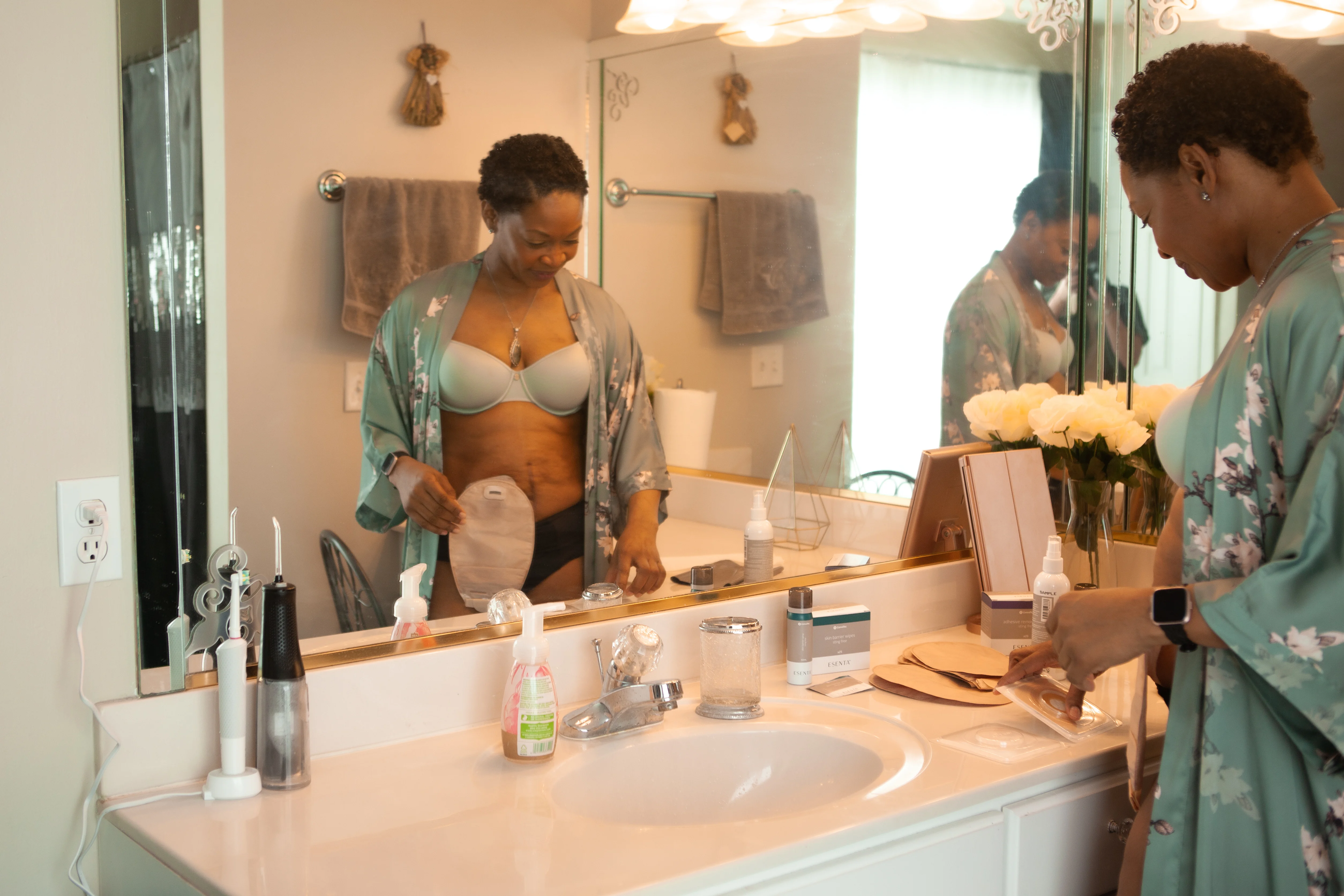 a woman with a stoma standing in a bathroom