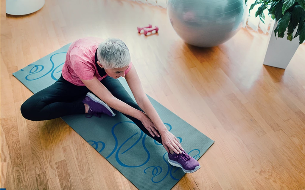 a person sitting on a blue mat